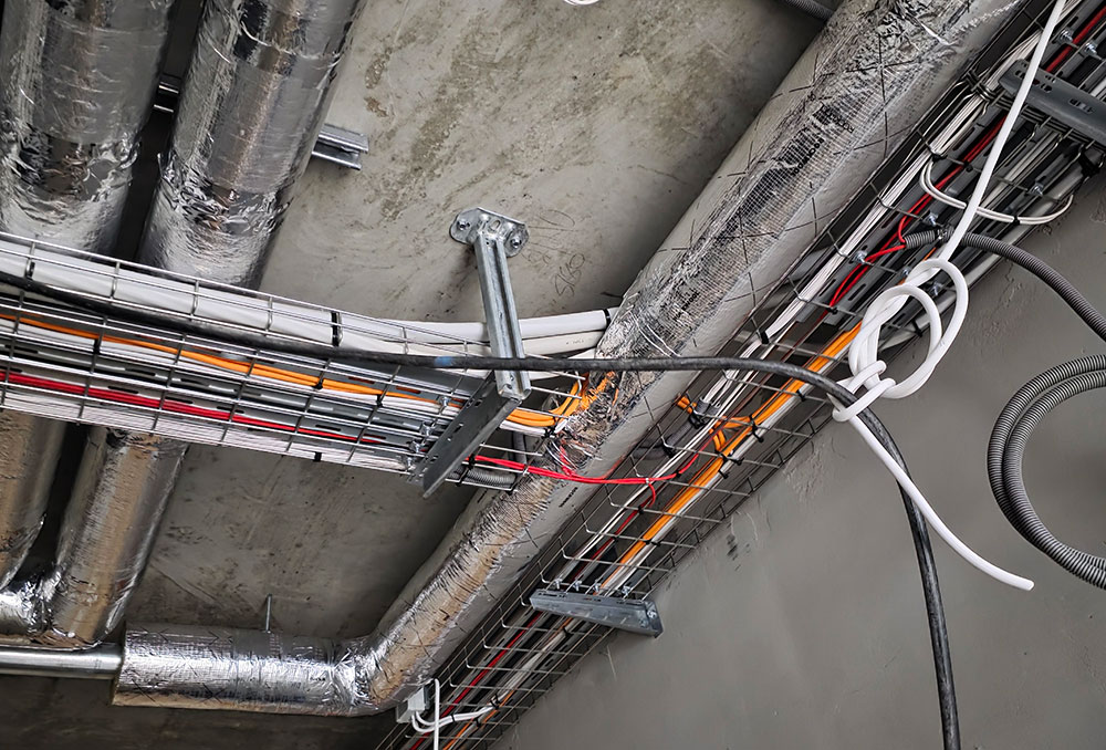 Electrical cable installation and routing in industrial ceiling using cable trays