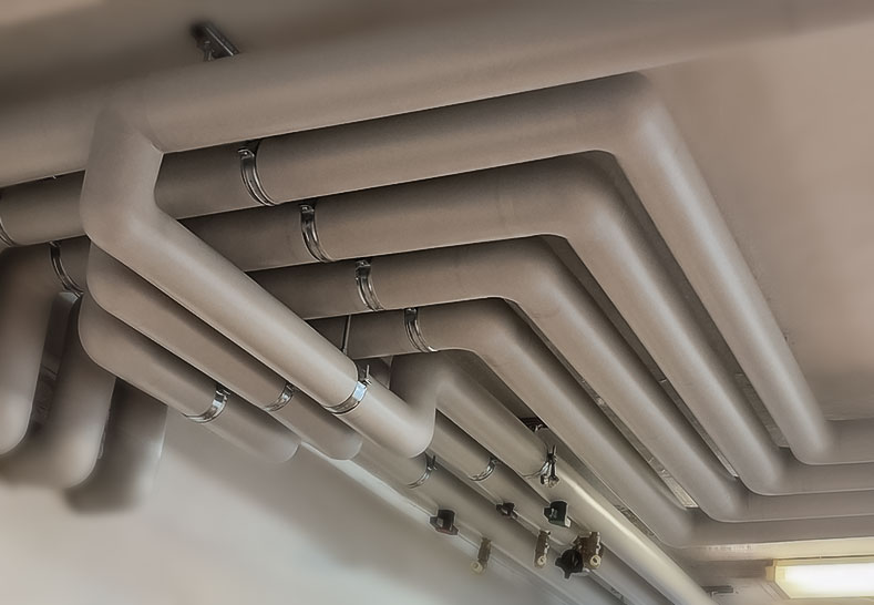 Professional insulation of water and heating pipes using Isover insulation and Isogen PVC jacketing for mechanical protection.