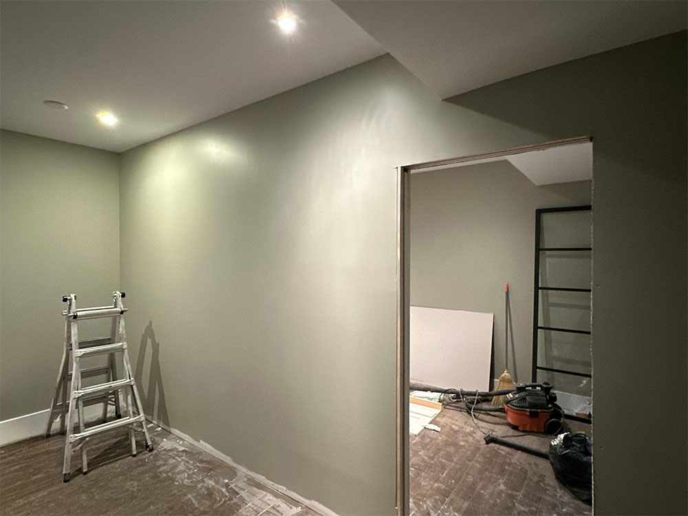 Interior painting work in progress with freshly painted walls during renovation