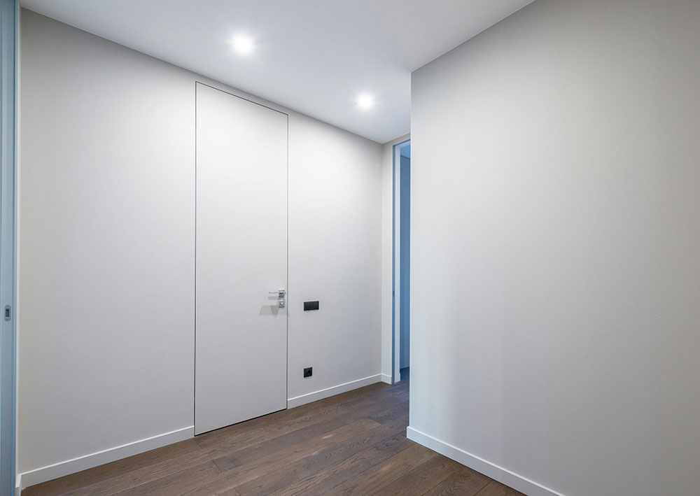 Finished interior painting with smooth white walls and completed surface finish