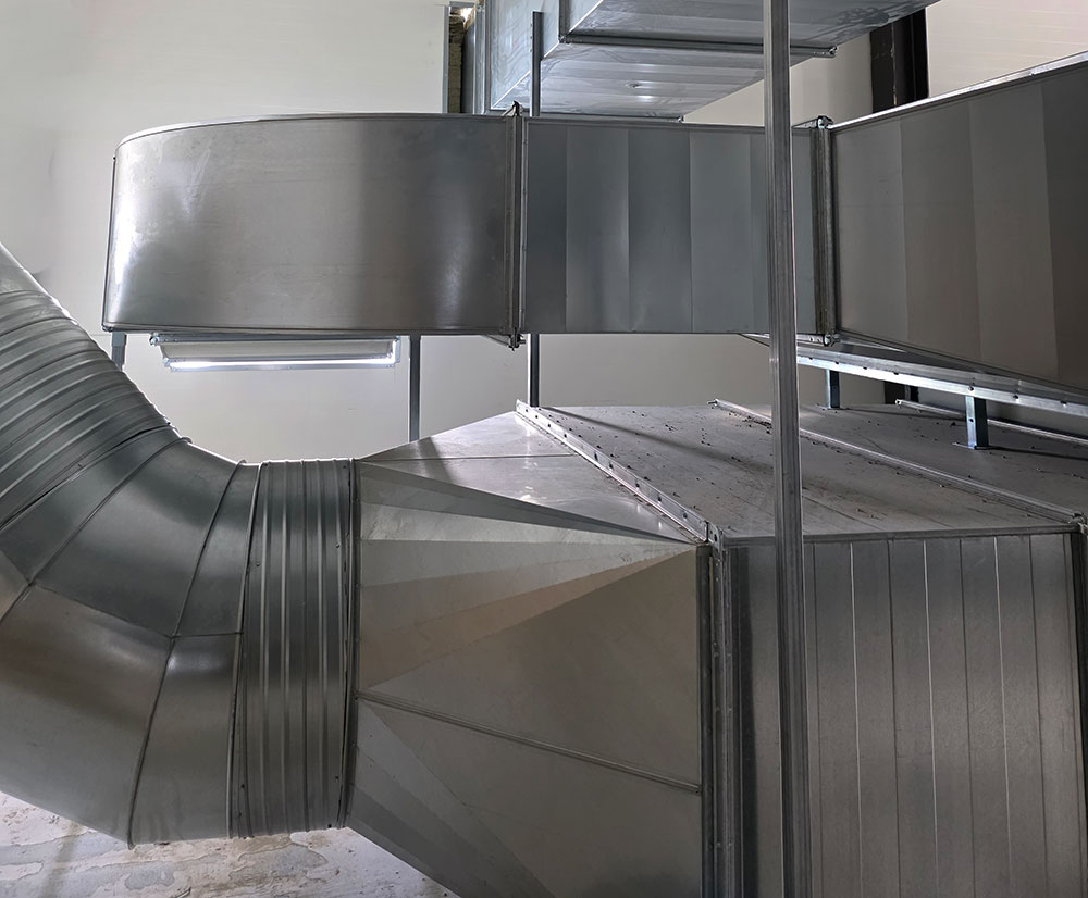 Industrial ventilation ducts installed in a commercial building, showing professional HVAC installation work.