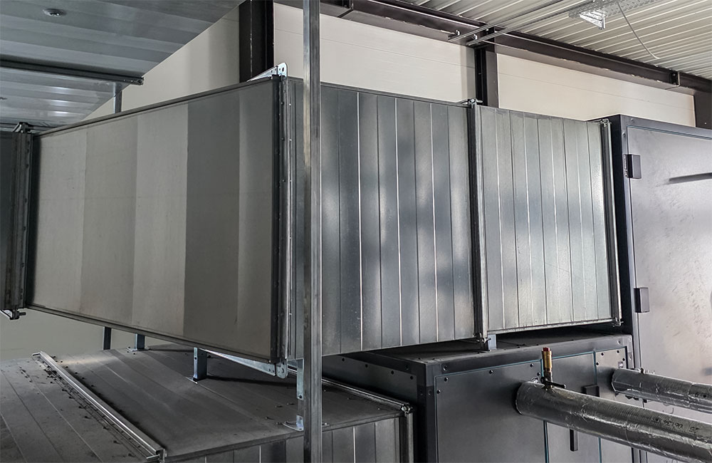 Rectangular ventilation duct system mounted indoors as part of a commercial HVAC installation.