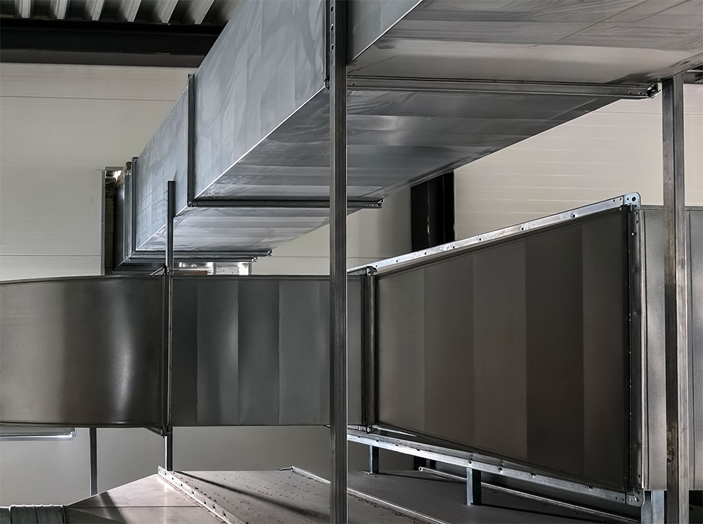 Large-scale ventilation duct installation inside an industrial facility.